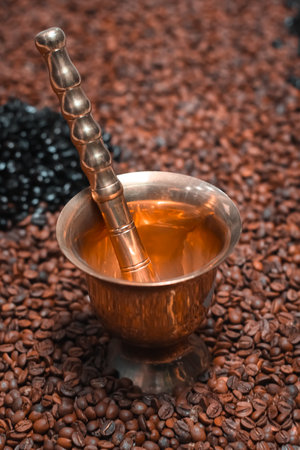 coffee mortar and pestle with coffee beans backgroundの写真素材