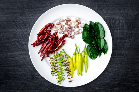 Group of ingredients and condiment on top of the table, Thai spicy ingredients, ingredients on dark wooden table, Thai ingredients with chili, garlic, lemongrass, lime leaf and basilの写真素材