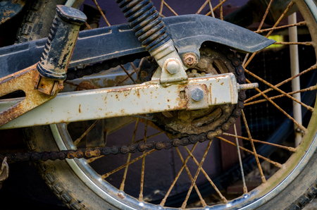 Old motorcycle parked on the wayside, Classic motorcycle with old wheel and old chain that have rustの写真素材