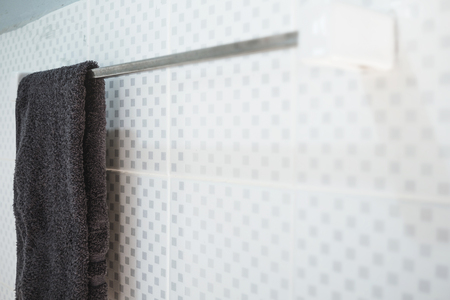 Bathroom interior and towel hanging on a railing, The towel hanging on a railing at the white wall in the bathroom.の写真素材
