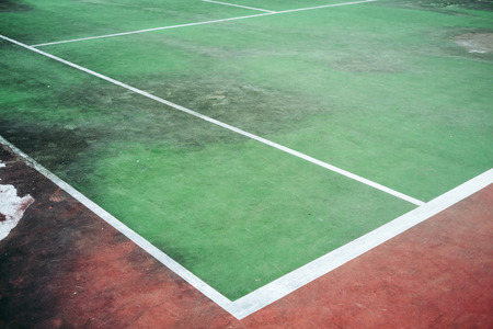 Old and vintage of green tennis court, The field line and corner of court, Dirty ground of tennis court.の写真素材