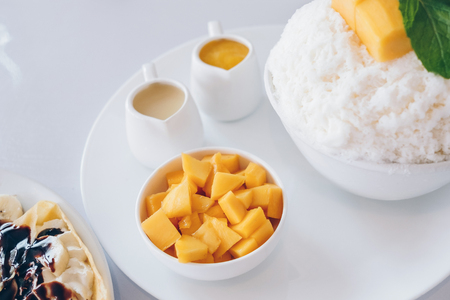 Bingsu mango (Korean Desserts) Shaved ice desserts with mango on top and sweetened condensed milk, Banana cold crepe (Japanese Desserts), Crepe with chocolate and vanilla ice cream. の写真素材