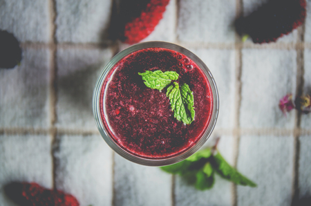 Top view of mulberry juice and mulberry fruit, Fresh berry fruit and berry smoothies with mint on white fabric.の写真素材