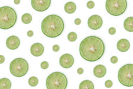 Close up of green lemon or lime on the white background, Fresh lemon(lime) slice and sour fruit or citrus fruit.の写真素材