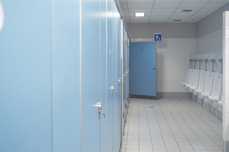 Public toilet and Bathroom interior with white urinals, Close-up of the wash bowl and chamber pot or urinal men with the stain dirty in the toilet.の写真素材