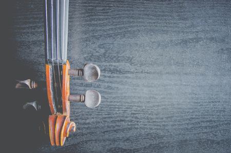 The violin on the dark table, Close - up of violin on the wooden floor, Top view of violin musical...
