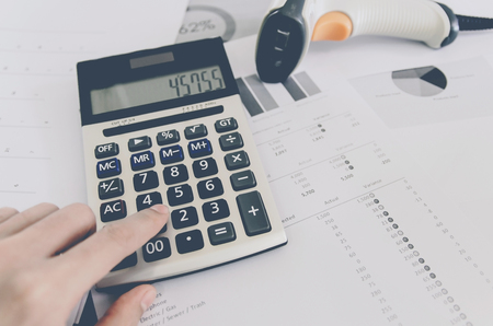 Show the business concept of financial and accounting, Finance report and calculator with paper sheet of planning data and analyze graph and chart on the table.の写真素材