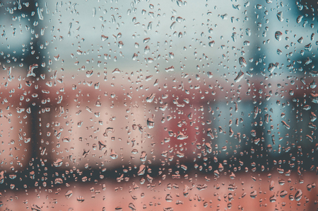 Wallpaper of rain drops or water drops on the glass, Vintage background by rainy drop on window, Rainy day with raindrop on the glass, Texture of water droplet on window glass.の写真素材