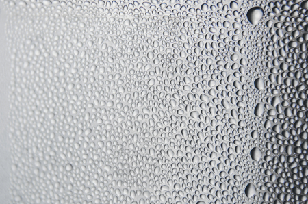 Wallpaper of rain drops or water drops on the glass, Vintage background by rainy drop on window, Rainy day with raindrop on the glass, Texture of water droplet on window glass.の写真素材