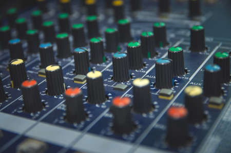 Audio mixer console and professional sound mixing. Audio mixer control panel with buttons and sliders. Mixer console for musician DJ and sound engineers.の写真素材