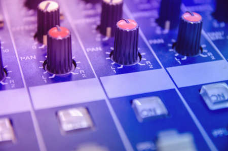 Audio mixer console and professional sound mixing. Audio mixer control panel with buttons and sliders. Mixer console for musician DJ and sound engineers.の写真素材