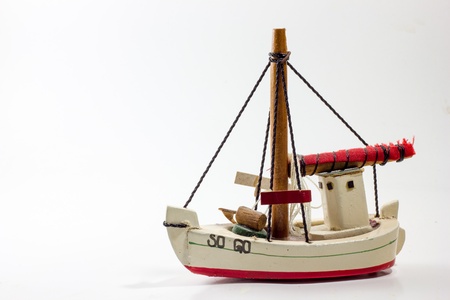 Old wooden toy boat white gird red