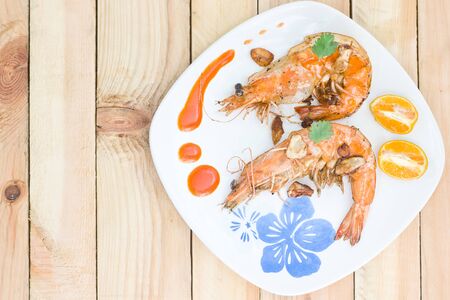 Fried shrimps on the white plate and vegetables.の写真素材
