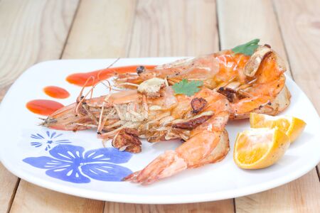 Fried shrimps on the white plate and vegetables.の写真素材