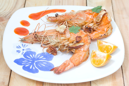 Fried shrimps on the white plate and vegetables.の写真素材