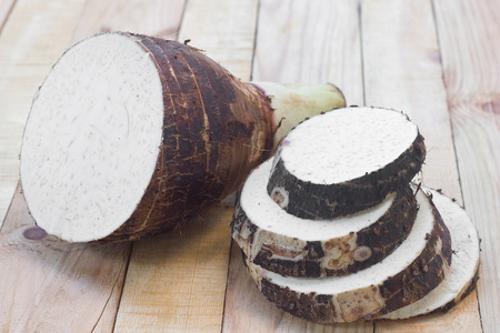 Taro root on wood background.の写真素材