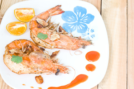 Fried shrimps on the white plate and vegetables.の写真素材