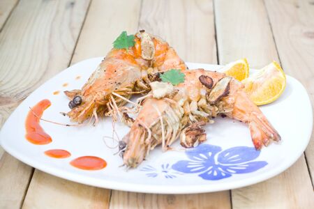 Fried shrimps on the white plate and vegetables.の写真素材
