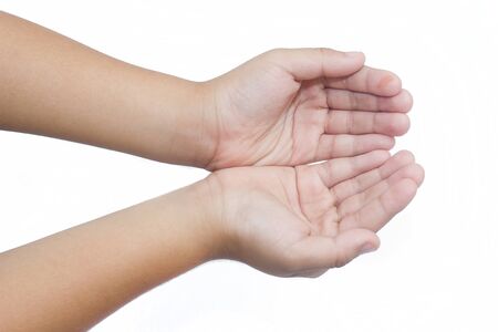 Outstretched cupped hands of the boy on white background.の写真素材