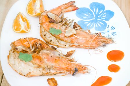 Fried shrimps on the white plate and vegetables.の写真素材