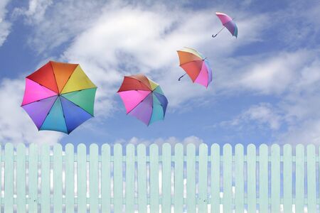 colorful umbrellas flying in a rich blue sky.conceptual image.