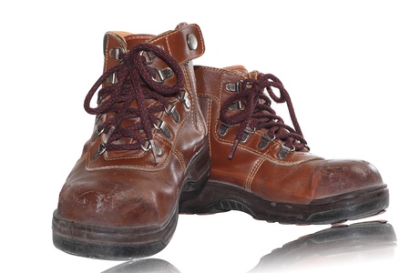 old brown boots isolated on whiteの写真素材