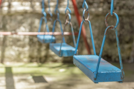Closeup of colorful swings in playground area at park の写真素材