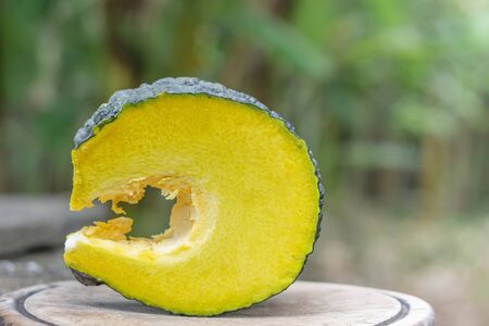 slice Piece of pumpkin on old wooden in garden 