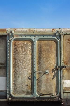 Vintage railroad container doors with rusty and old color on blue sky.の写真素材
