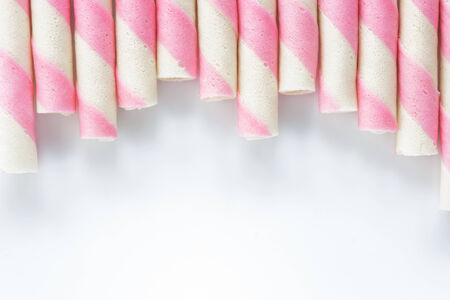 Closeup pink stripe wafer rolls on white Background  の写真素材