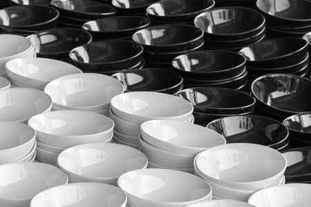 Stack of black and white plates in warehouse.の写真素材