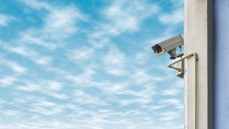 Security camera on blue sky background.