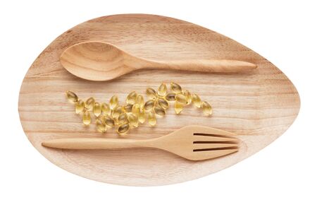 Cod liver oil  gel capsules on wooden plate isolated white background.clipping path.の写真素材