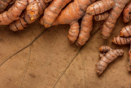 Stack of turmeric on  dry leaf.の写真素材