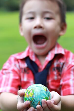 Globe in hand boy, I love the worldの写真素材