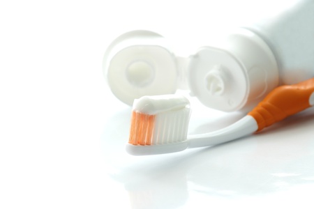 Toothbrush and toothpaste on a white background