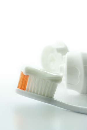 Toothbrush and toothpaste on a white background