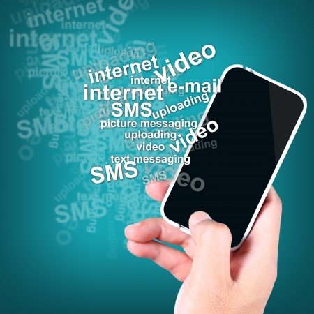 Hand holding a smart phone with the text many featuresの写真素材