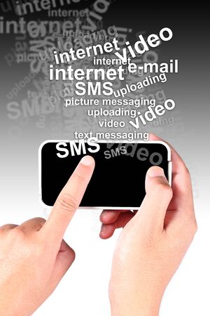 Hand touching smart phone with the text many featuresの写真素材