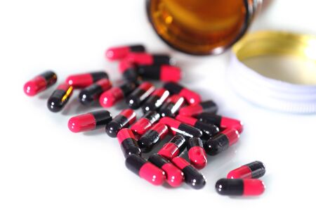 Close up of capsules out of bottleの写真素材