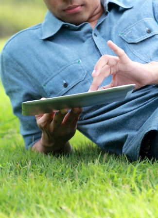 Man Using digital tablet in the parkの写真素材