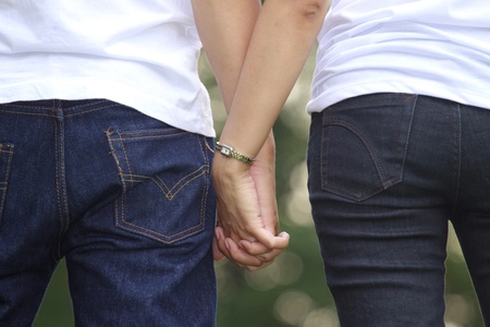  Young couple holding hands  in the park