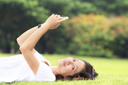 Woman doing activity on her mobile phone in outdoorの写真素材
