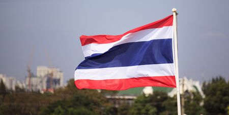National flag of Thailand with a city backgroundの写真素材
