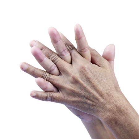 Closeup of senior hands on white background