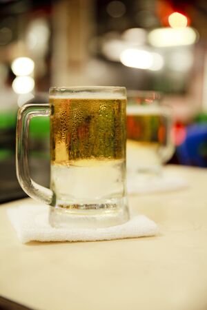 Glass of beer in restaurantsの写真素材