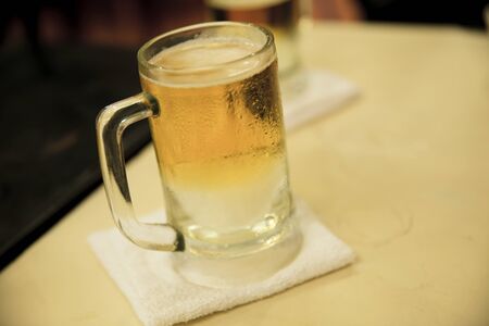 Glass of beer in restaurantsの写真素材