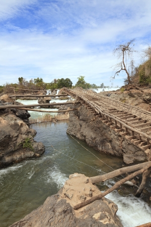 Wooden bridge in the Khone Phapheng Waterfall, Champasak Province on the Mekong River in southern Laosの写真素材