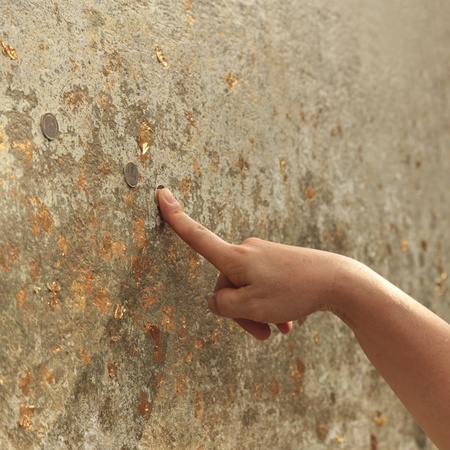 Hand of asian woman praying buddha with coins and prayerの写真素材