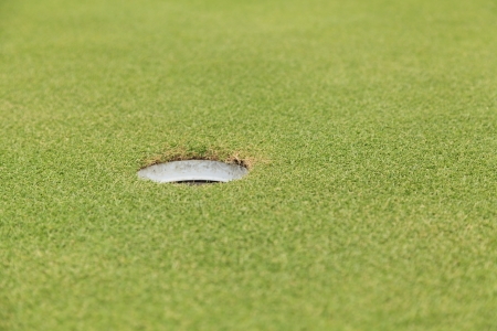 Golf hole on green grassの写真素材